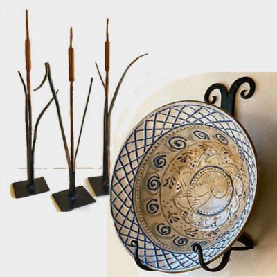 3 wrought iron catails and a bowl set in a bowl holder.