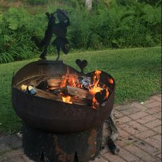 Metal fire pit with fire burning.