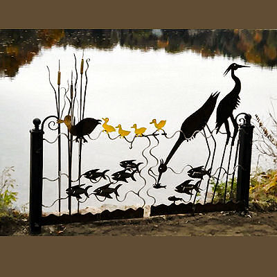 Gate with birds and fish over-looking a pond.