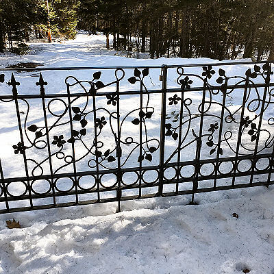 Gate with decorative leaves and vines.