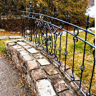 Railing over stone wall.