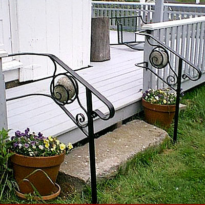 Double railings at the entrace of a low porch.