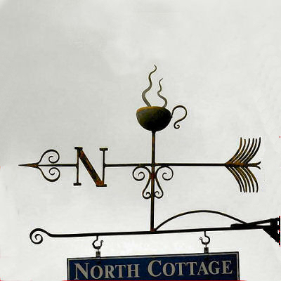 A weathervane sign with steaming coffee cup.