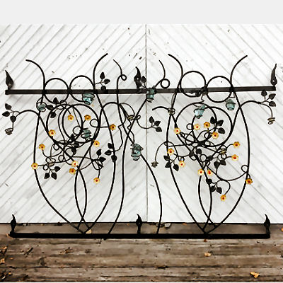 Wrough iron grill with flowers and glass balls.